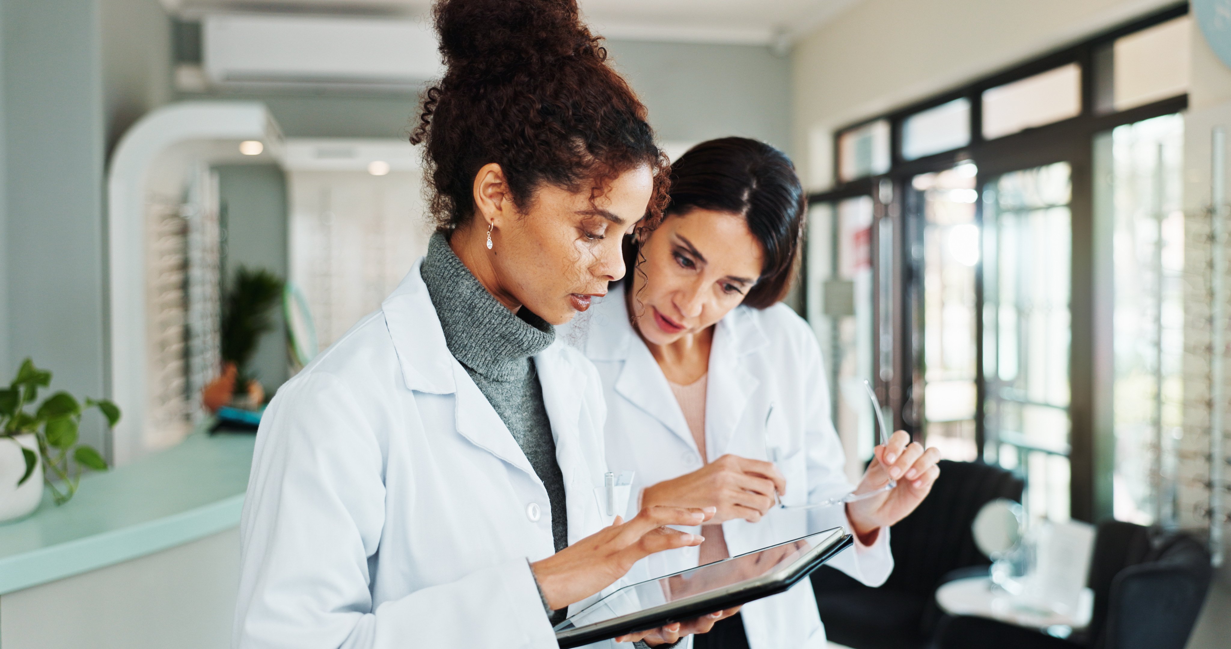 two women doctors looking at patient files