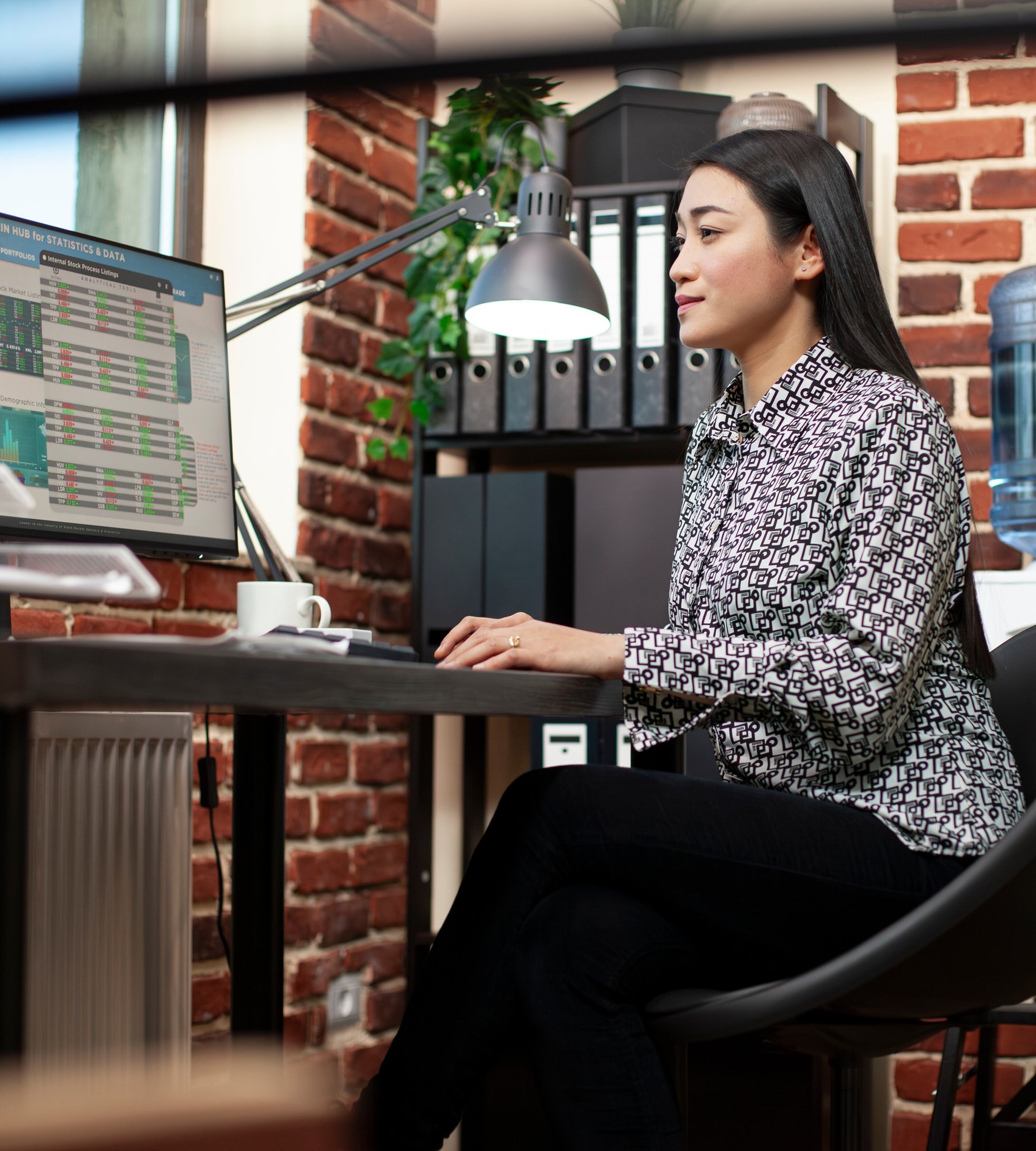 Business woman looking at reporting data on computer