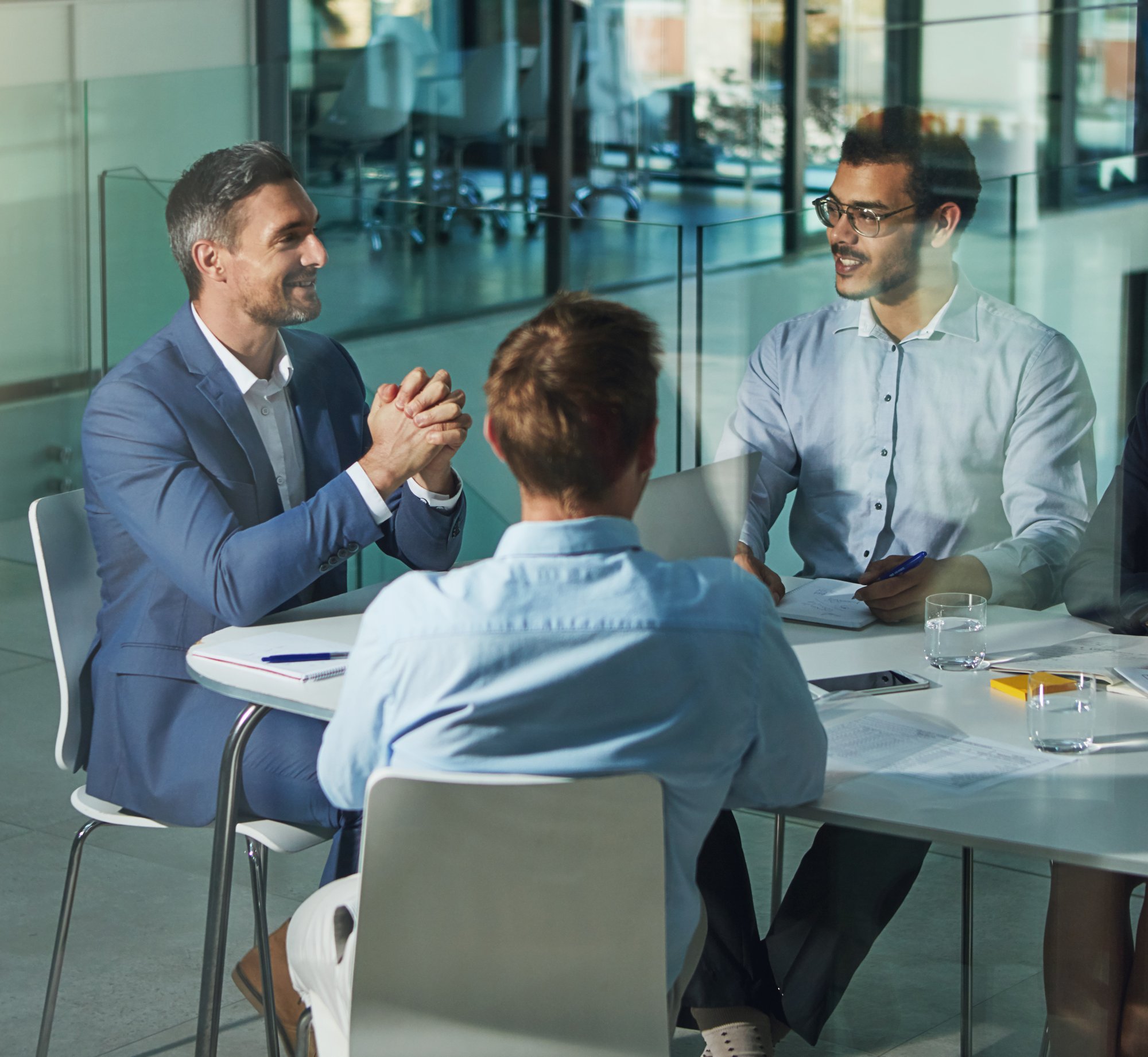 three business men holding a meeting at conference table