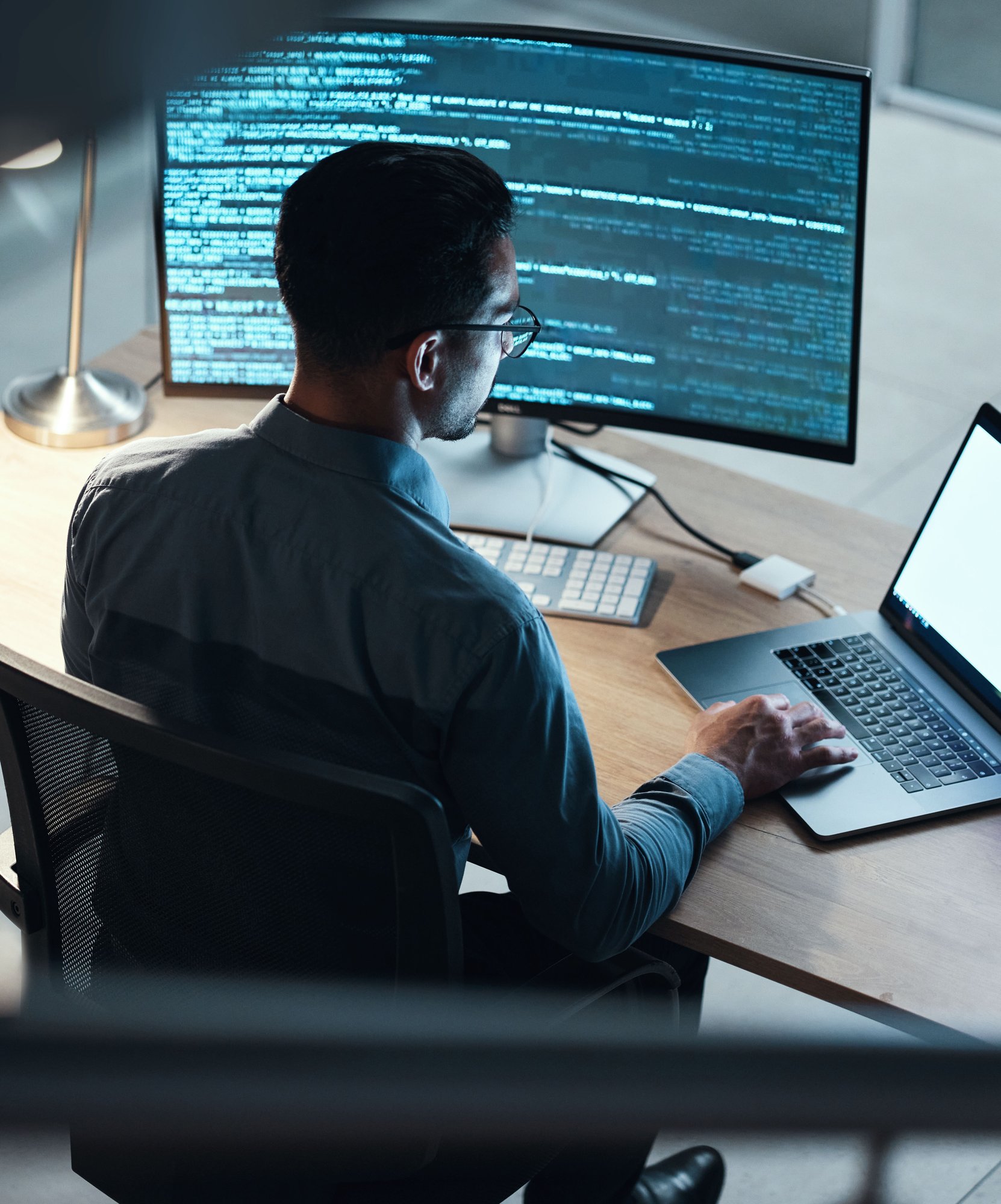 man coding on computer in office