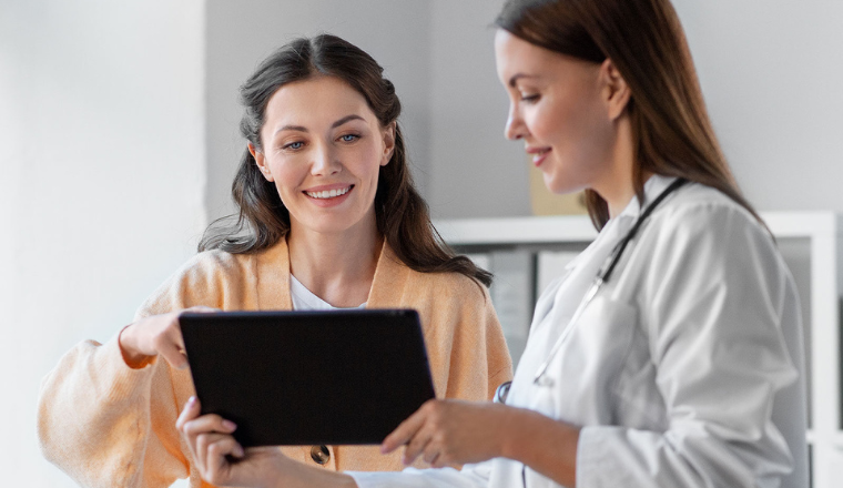 doctor showing patient something on tablet