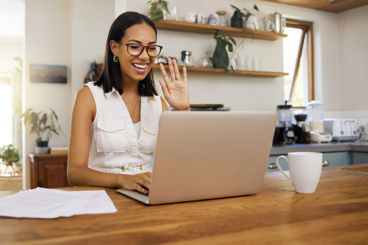 woman video chatting with someone on laptop