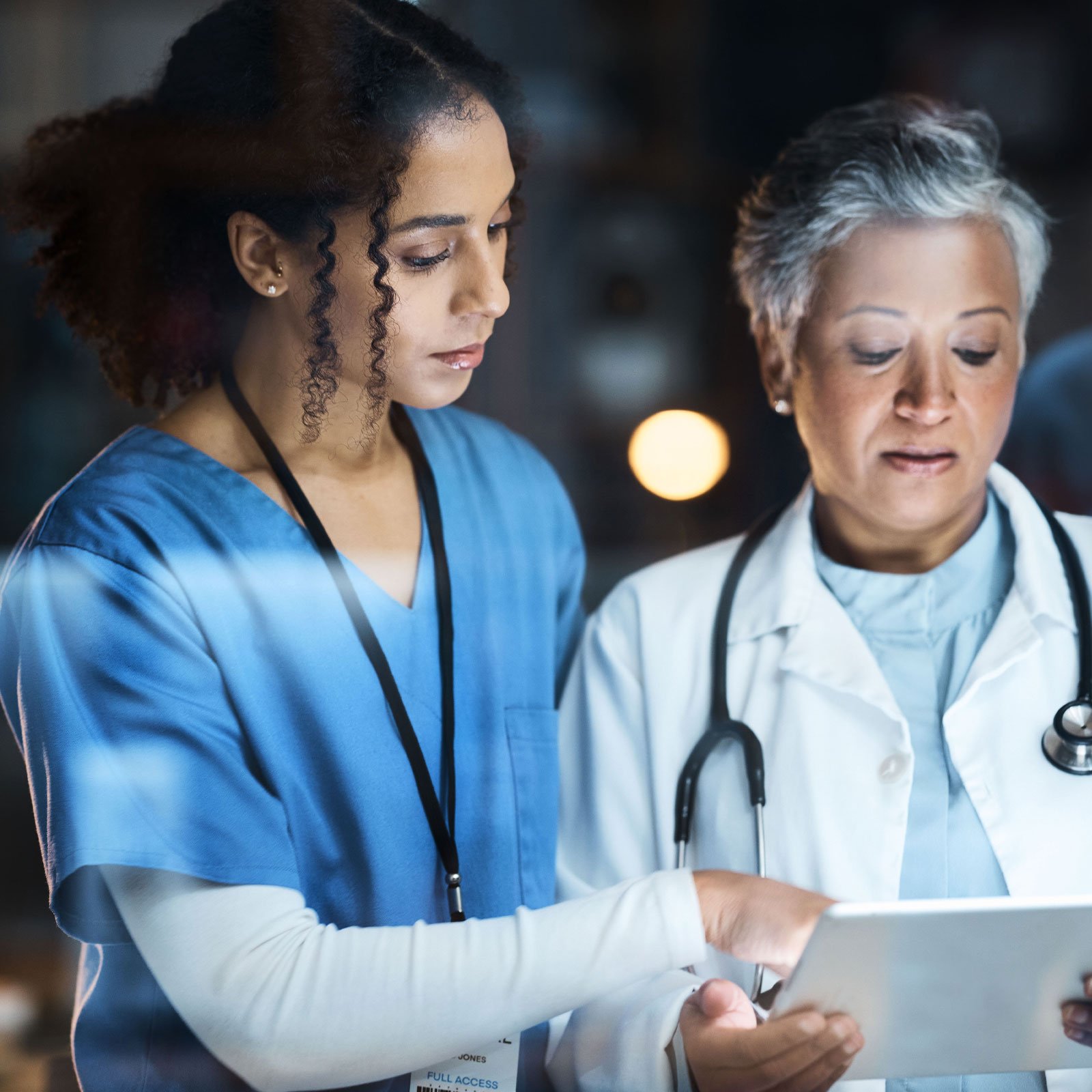 two doctors looking at a tablet together