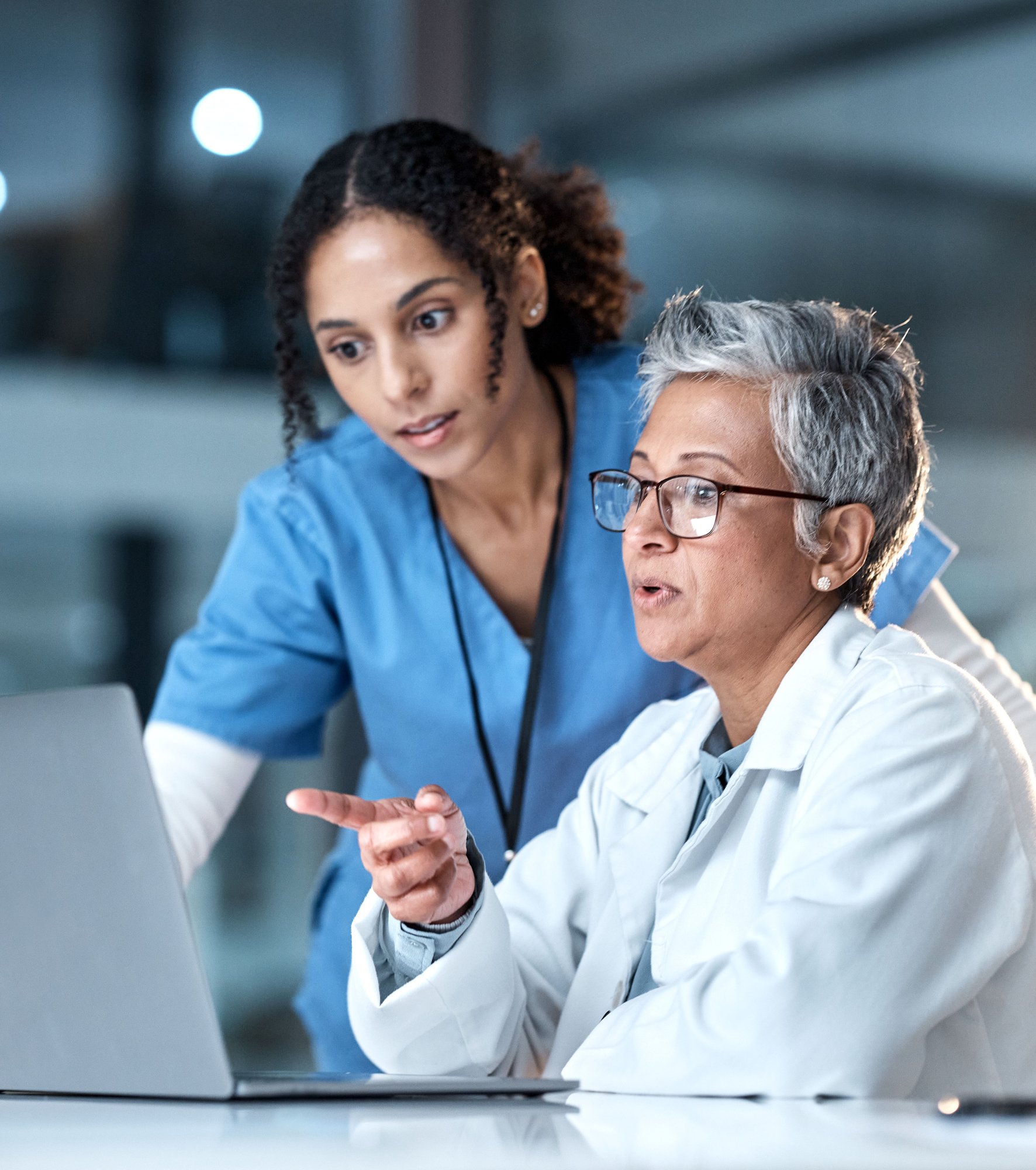 two women doctors looking at computer in healthcare office