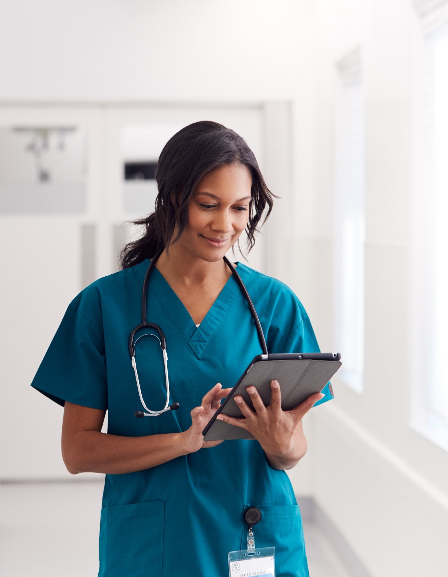 woman doctor nurse looking at tablet